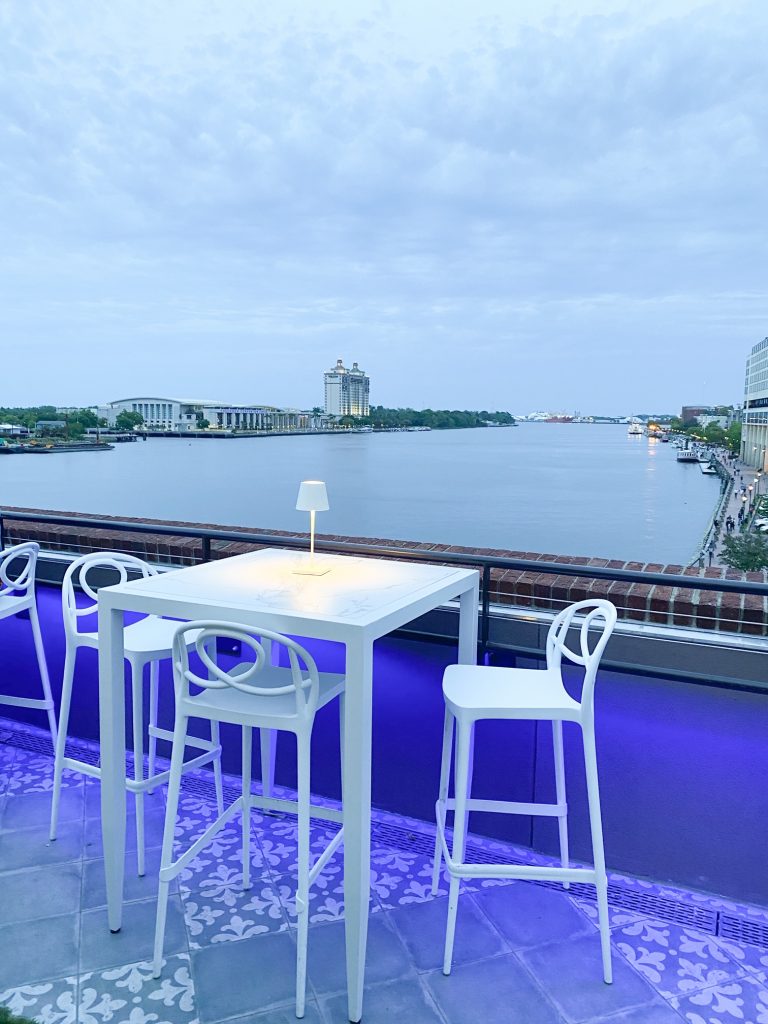 Elegant table and chairs decorate the Myrtle and Rose Rooftop Gardens at the Plant Riverside District. 