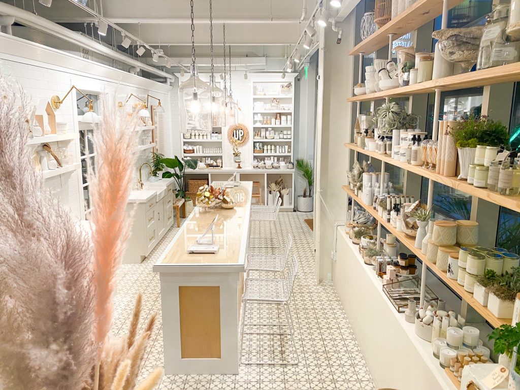 Shelves are lined with plants and vases at Urban Poppy. 