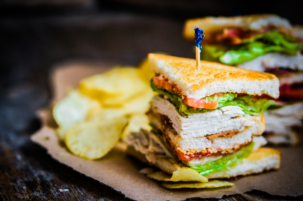 A turkey club sandwich with chips 