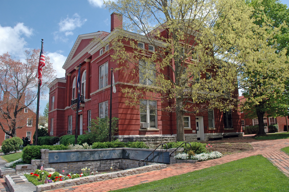 A red brick building with blossom in the foreground.