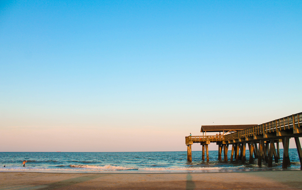 beach and fishing pier over water