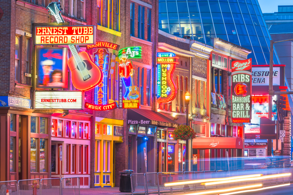 A picture of several shops and stores with their neon signs and lights in Lower Broadway in Nashville, Tennessee.