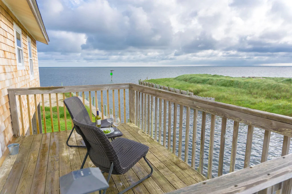 Photo of two chairs on a deck overlooking the ocean at Channel House, one of the best Outer Banks vacation rentals. 