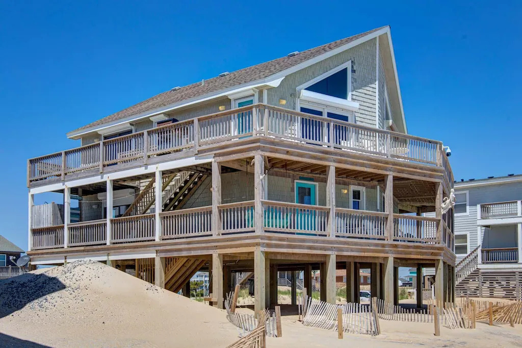 Photo of the exterior of Mermaid's Tears,  a two story beach home with wrap around decks. 