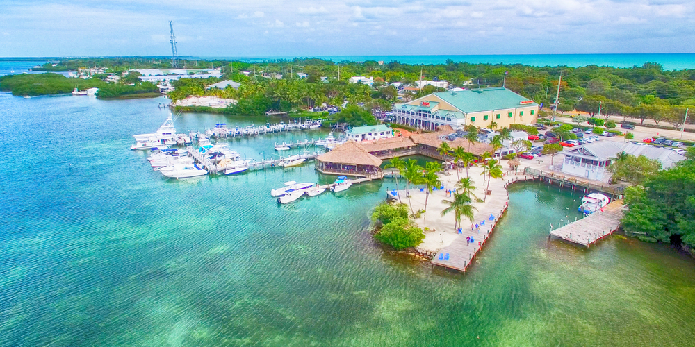 aerial view of wooden boardwalks, boats, and buildings along the coast line