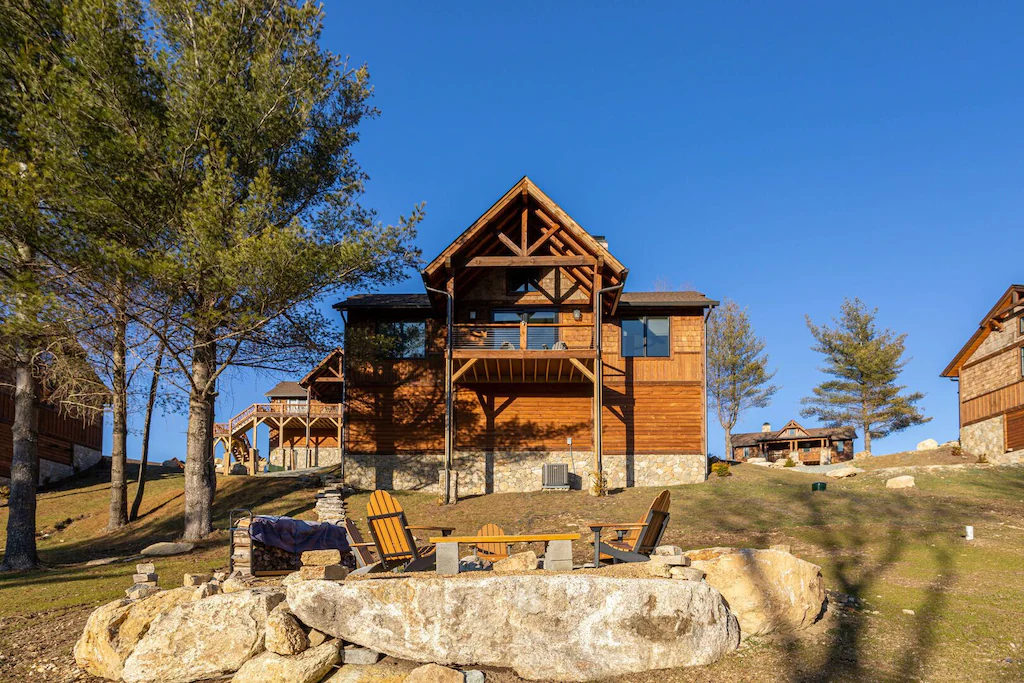 The cabin called Big Little Bear sits on top of a small hill using the beautiful natural rocks as a sitting area outside.