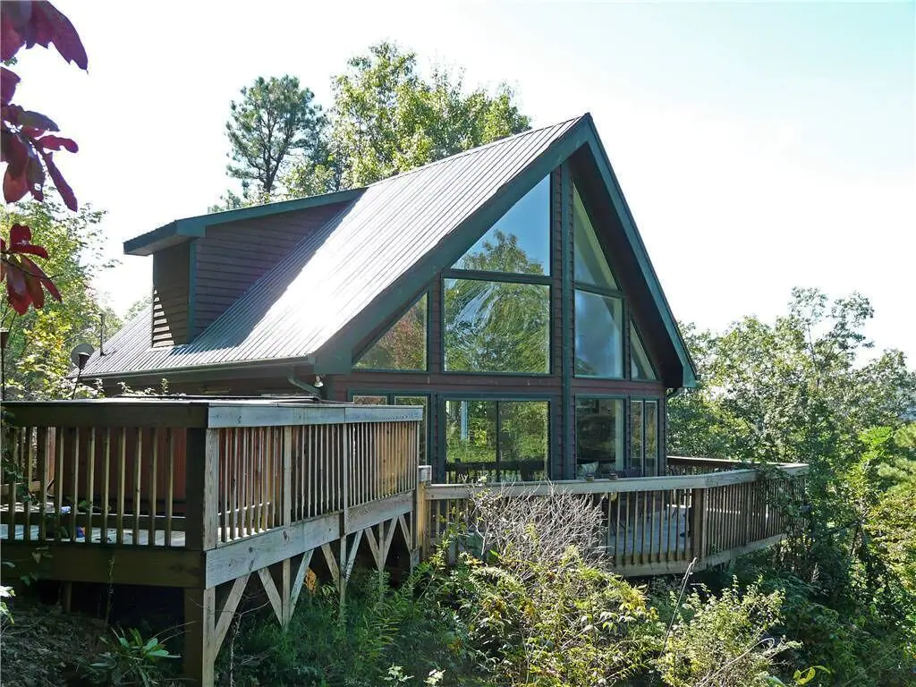 This cabin nestled in the mountains of North Carolina has many windows for spectacular views