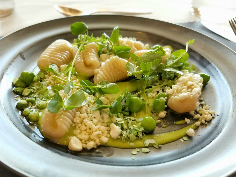 At Planta a vegan restaurant in Asheville they served a gnocchi in green pea purée with fresh snap peas, micro greens and a vegan cheese served on a black plate