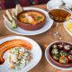 a spanish style tapas dinner with olives, ceviche, wine and more