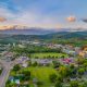an aerial view of one of the cutest small towns in Tennessee. You can see grassy areas, small buildings, and mountains in the distance.