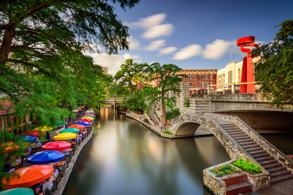 photo of a bridge and restaurant seating on the San Antonio riverwalk