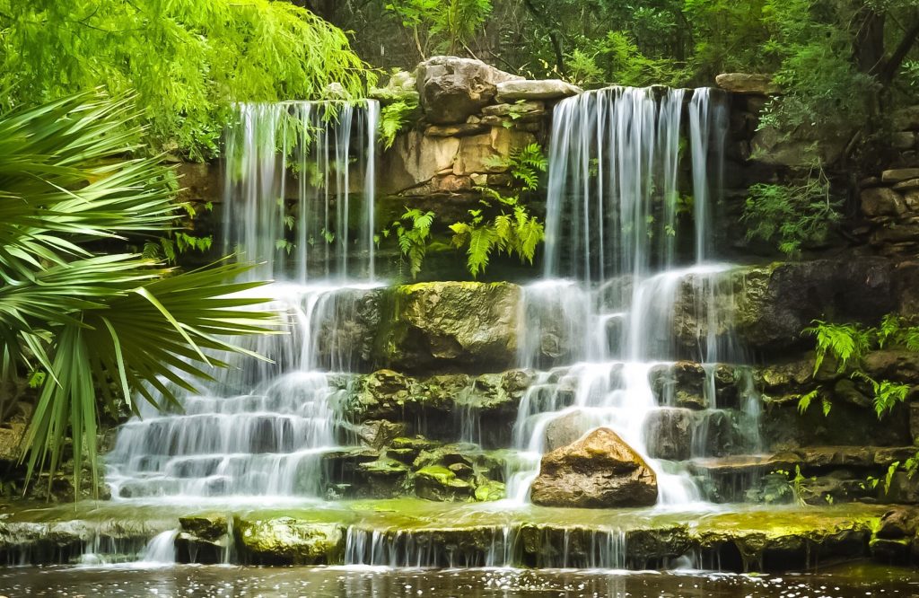 A gorgeous waterfall cascades at Zilker Botanical Gardens