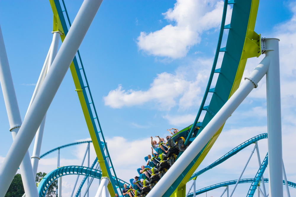 Roller coaster in motion in front of a blue sky at Carowinds, one of the best things to do in Charlotte.