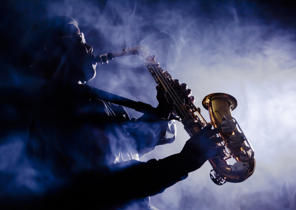 Jazz musician playing saxophone in the fog.