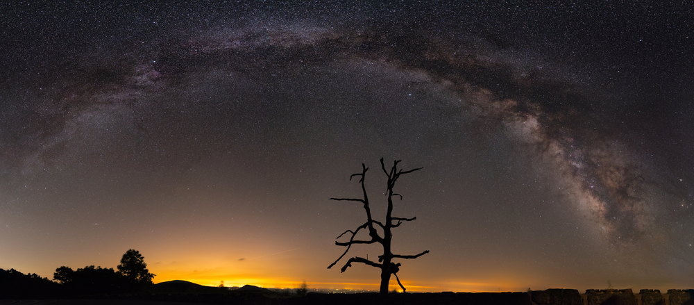 A panorama photo of the night sky capturing the milky way in Shenandoah National Park.