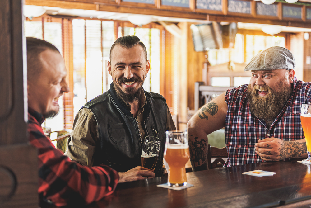 Three men drinking beer in a pub