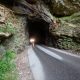 spooky car headlights driving through cave at one of the most haunted places in kentucky