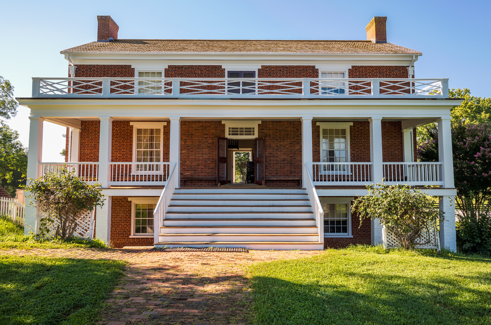 View of the front of Appomattox Courthouse with grassy lawn and open doors.