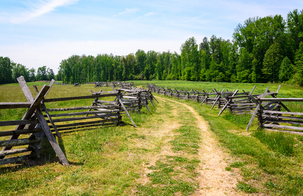 Fields with a path cutting through and bordered by a wooden fence at Richmond Battlefield