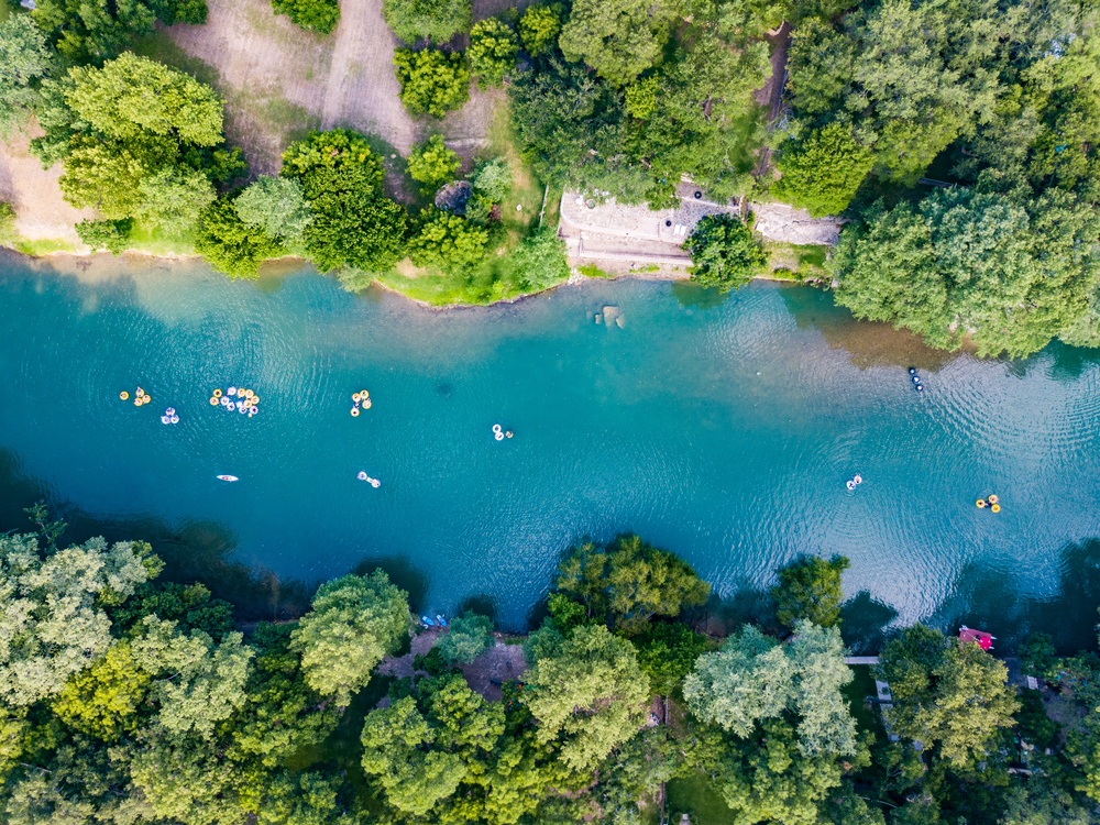 An aerial shot of people tubing on the Guadalupe River, one of the most fun things to do in Canyon Lake, TX.