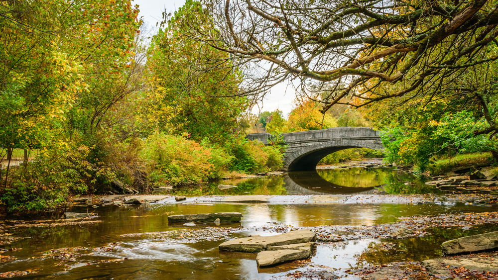 creek going under arched brudge