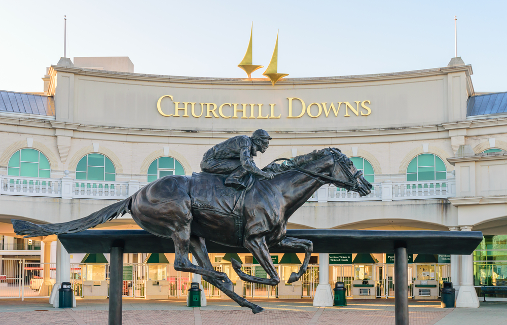 horse and jockey statue in front of churchill downs building in lousiville