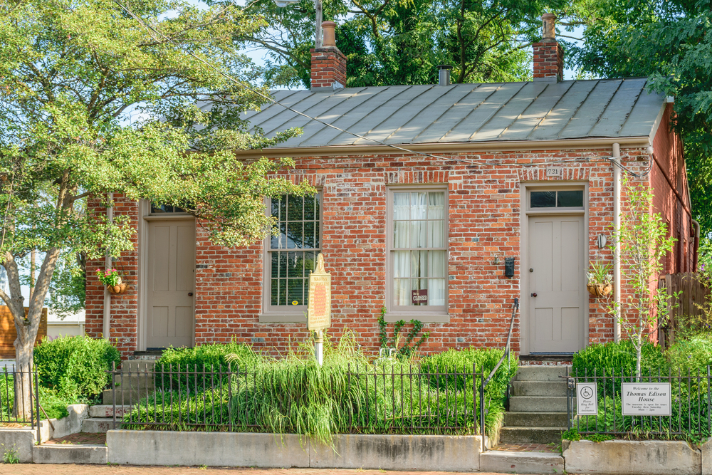 brick building with a little grass garden in front