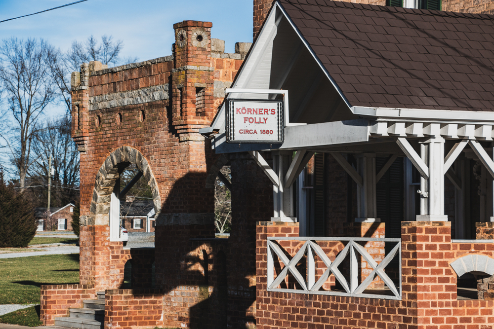 the front of korners folly, brick building with wood and stone design work