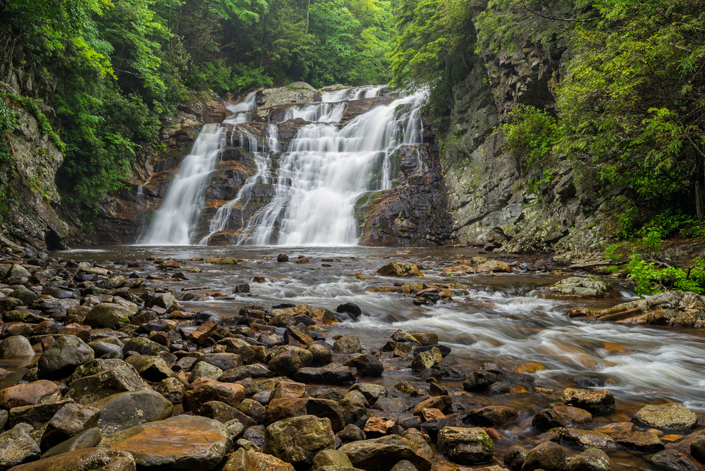 Laurel Falls cascading down a rock face into a river.