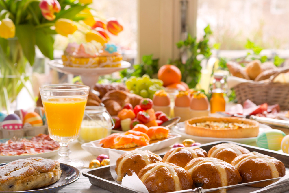 Assorted brunch foods with flowers served on a table.