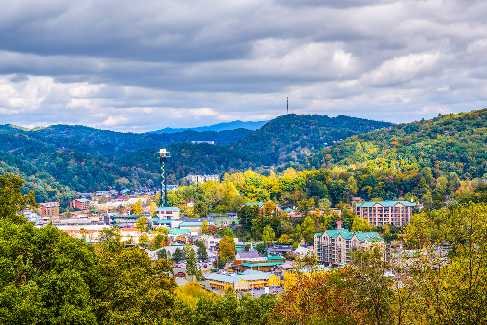 Panoramic view of Gatlinburg surrounded by trees and mountains.