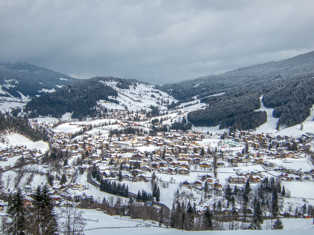 An aerial view of the small town of Gatlinburg Tennessee in the winter. Its one of the best Christmas in the south destinations. It is covered in snow and you can see lights coming from the buildings and the sky is overcast and gray.