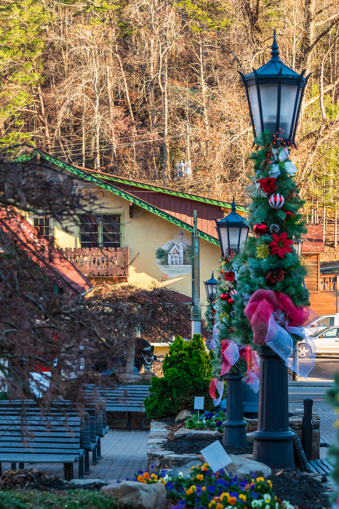 Looking down the street in Helen, Georgia. The light poles are decorated for the holidays with greenery, ornaments, and red and white ribbons. 