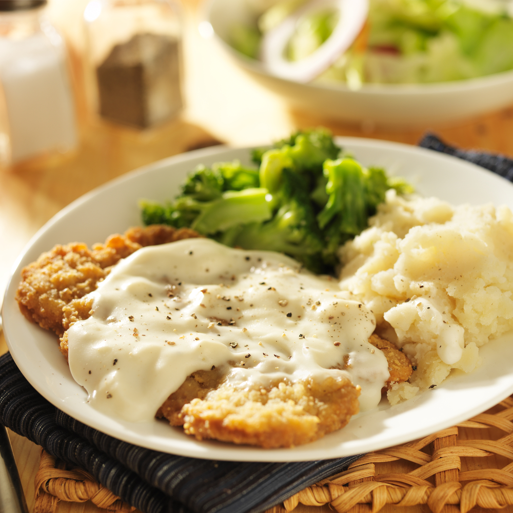 country fried steak with gravy, mashed potatoes, and broccoli 