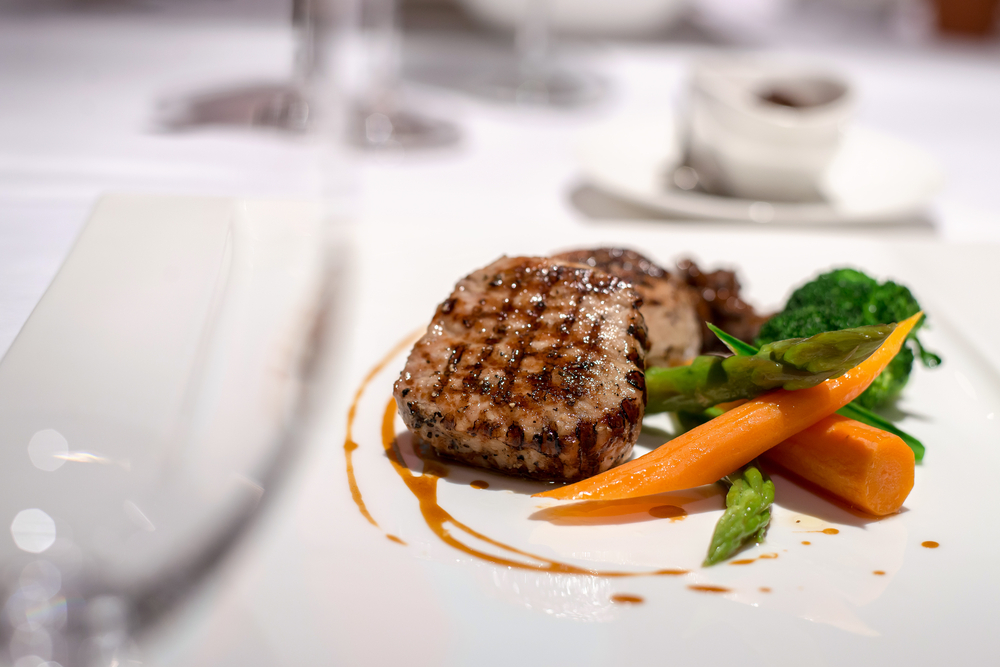 steak, carrots, and asparagus on a white plate