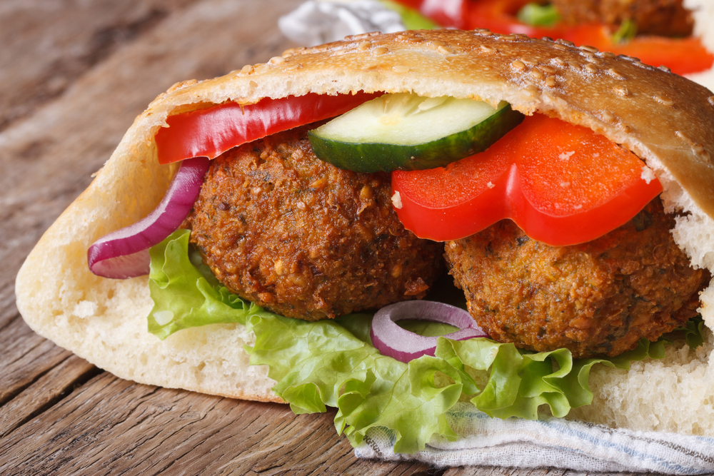 falafel pita with tomatoes, cucumber, lettuce, and onion