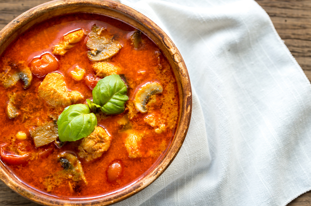 red thai curry in a wooden bowl