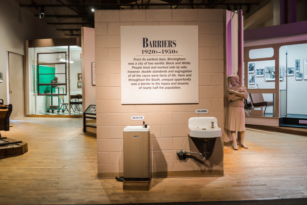 Civil rights institute display of segregated drinking fountains, one titled "white," and the other "colored."