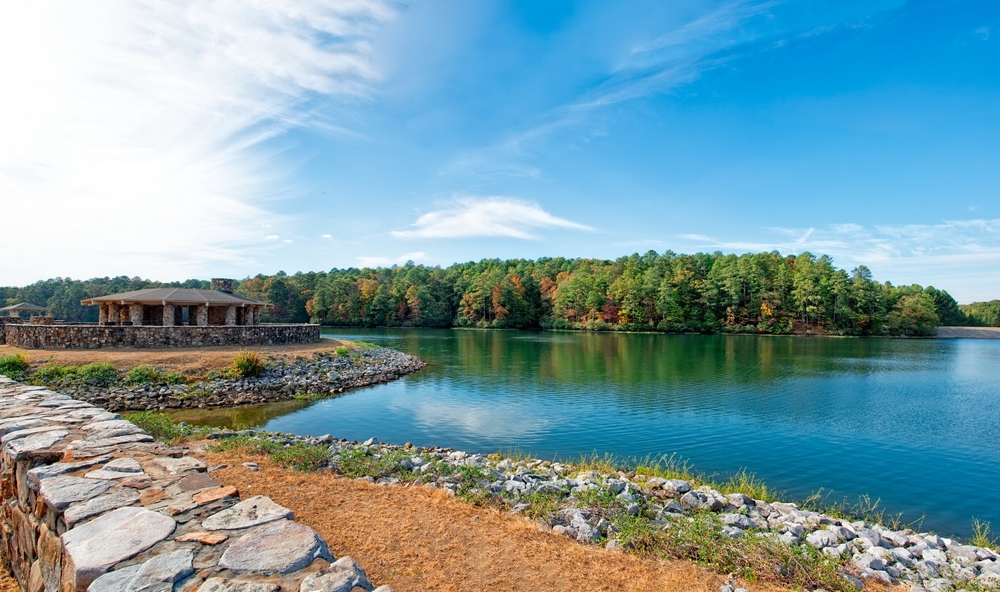 Oak Mountain State Park, one of the best things to do near Birmingham, with a forest in the background and a blue lake.
