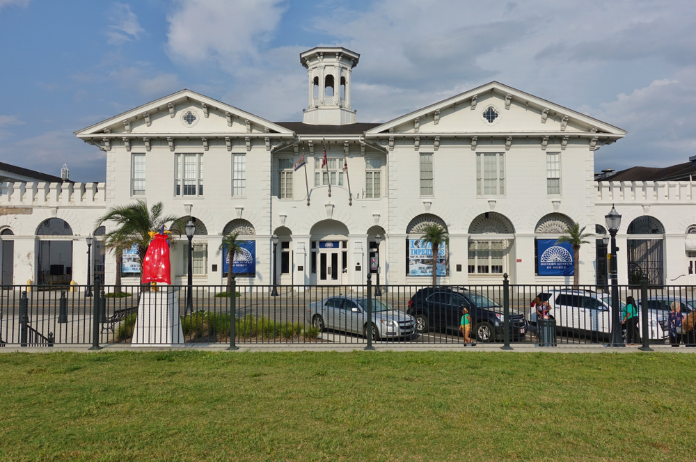 the white history museum of Mobile Alabama with a black fence and grassy area