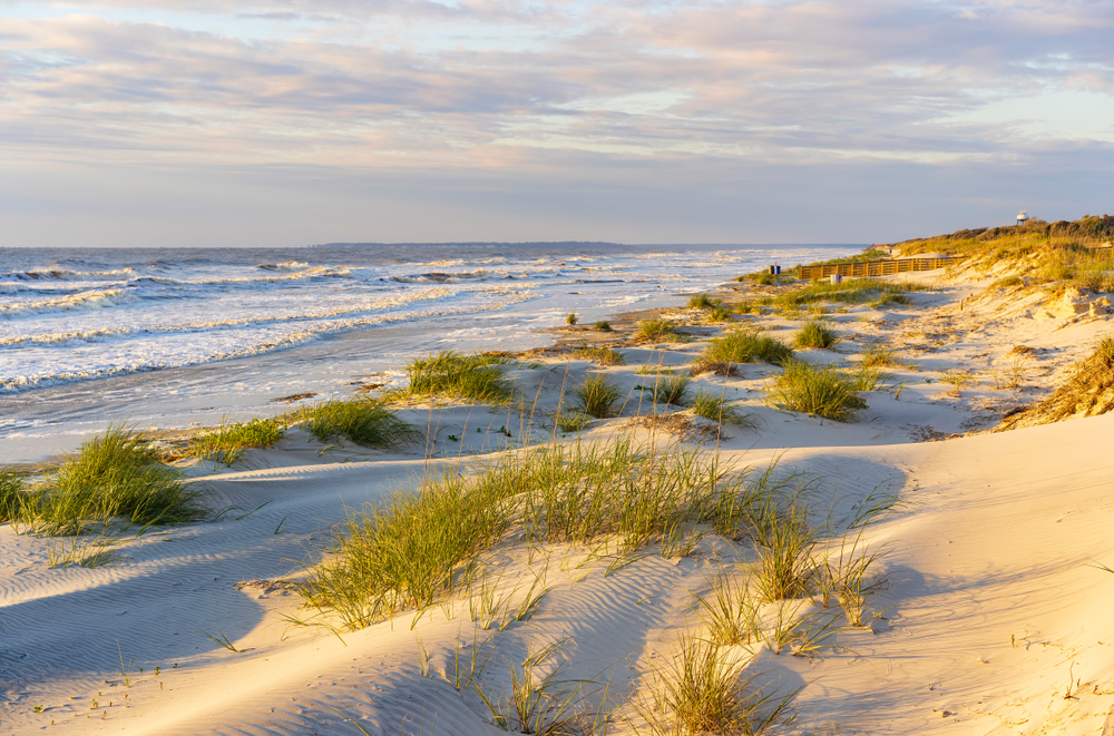 Sunrise on the waves and sand dunes of one of the beaches in Georgia.