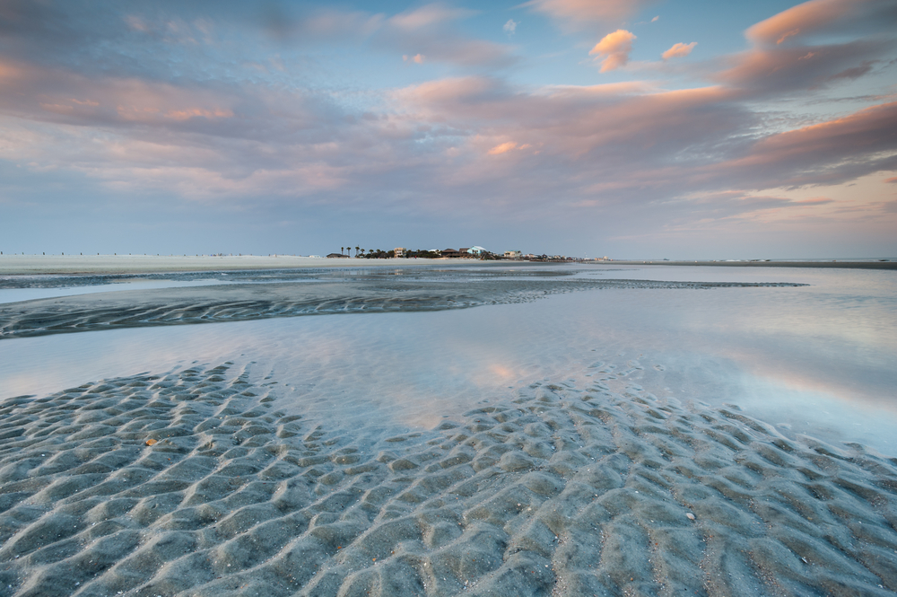 large sandy beach at sunrise, folly beach, one of the most popular beaches in charleston