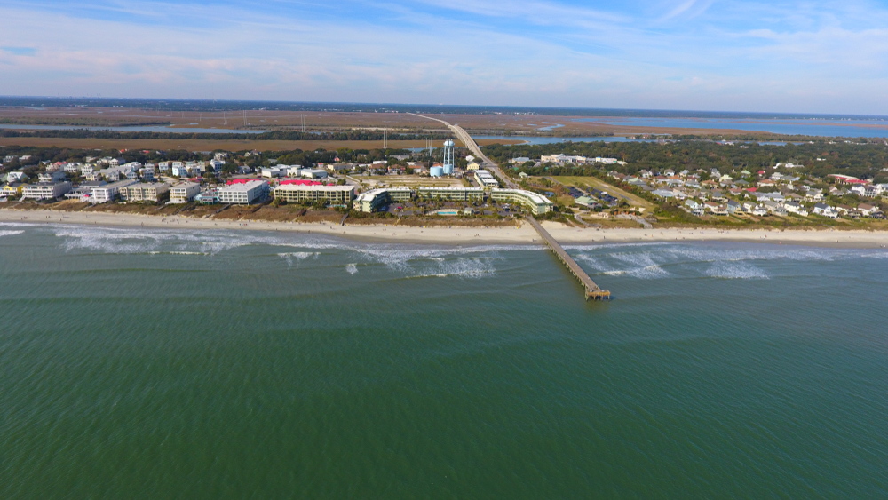 photo of ocean, pier, and beachfront buildings from above