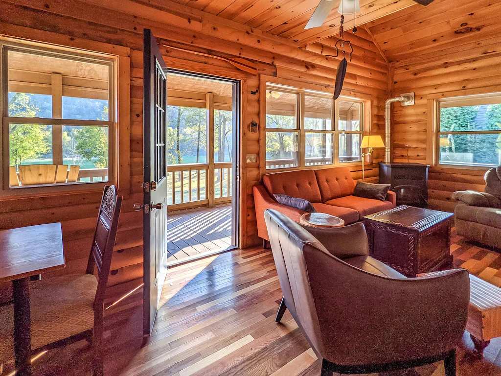 living area of cabin with front door open to front porch