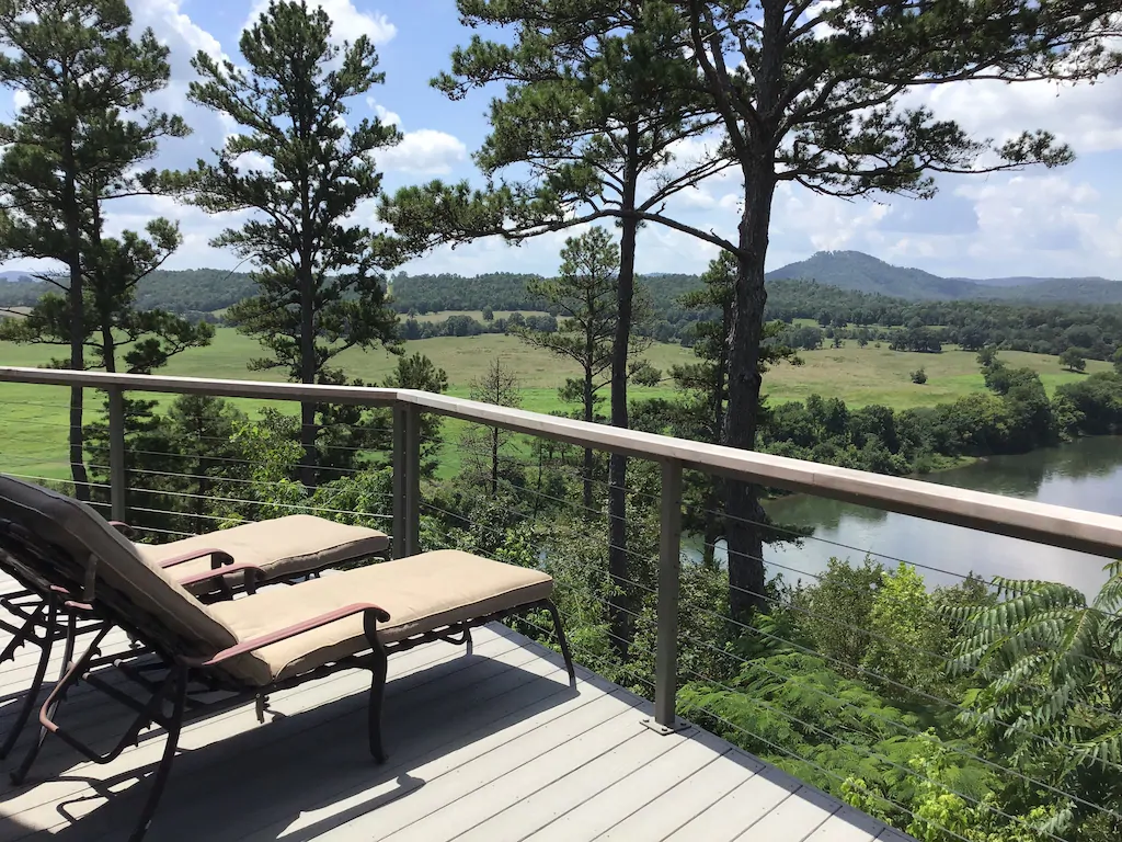 lay back deck chairs on deck overlooking a river and field