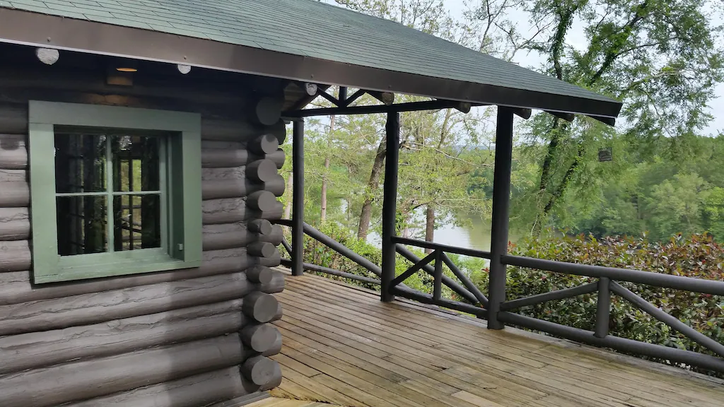 front porch of log cabin overlooking water