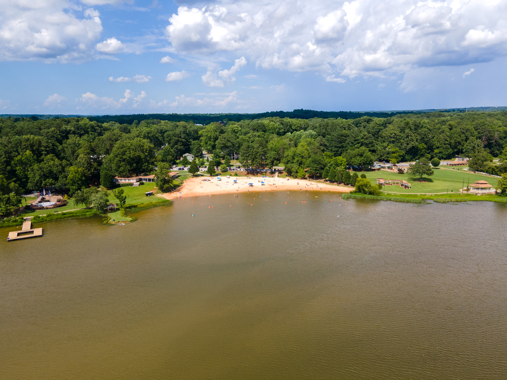 A swimming beach, surrounded by trees, on Lake Acworth, one of the closest beaches near Atlanta, GA.