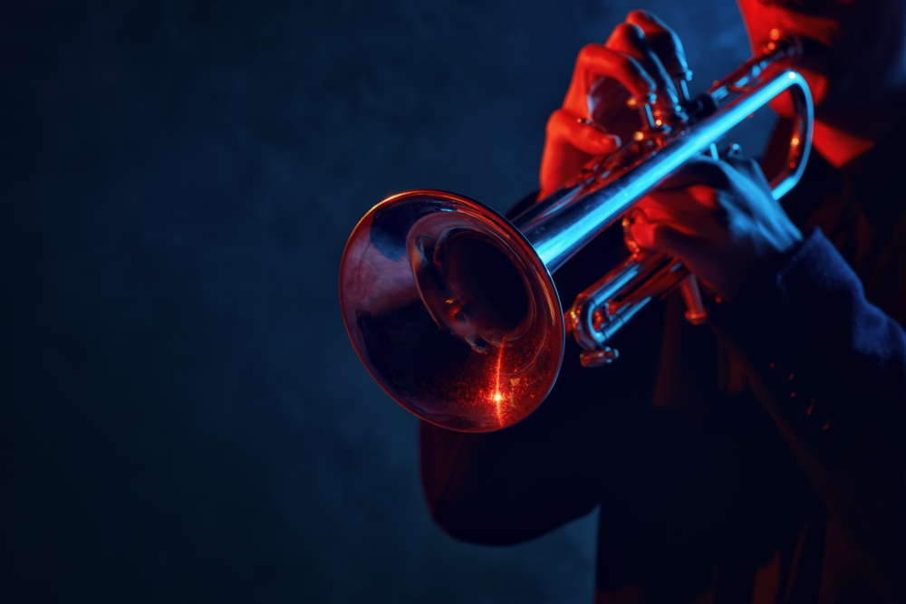 Close up of a jazz musician playing the trumpet. Listing to jazz at a club is one of the best things to do in Georgetown 