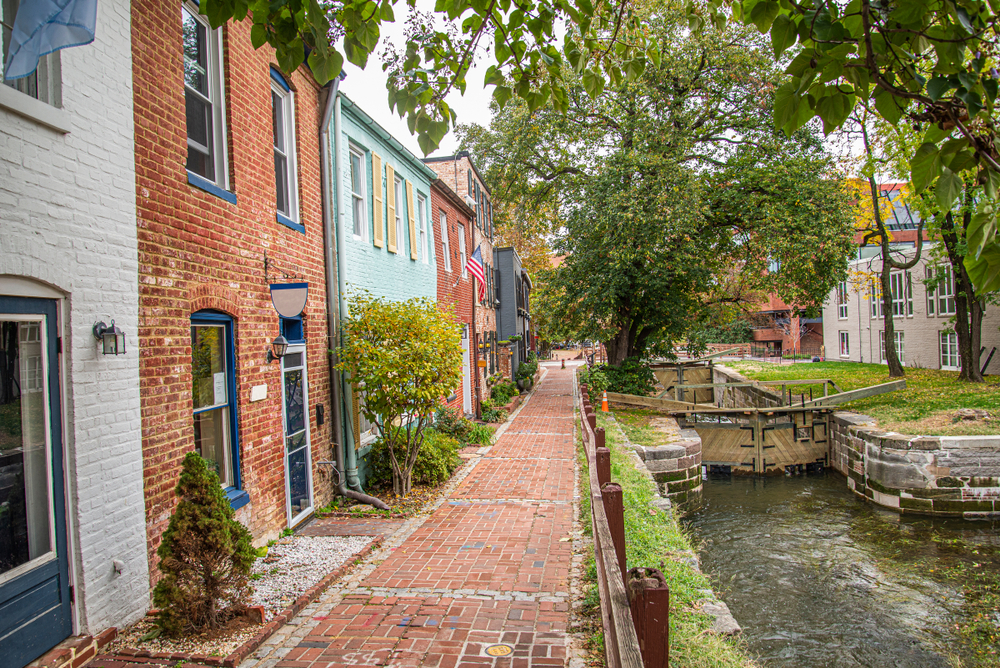 The pretty canal running along a brick pathway next to cute houses in Georgetown.