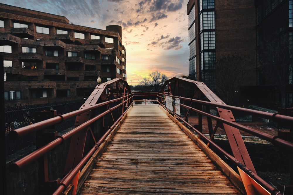 A canal bridge at sunset, looking spooky.